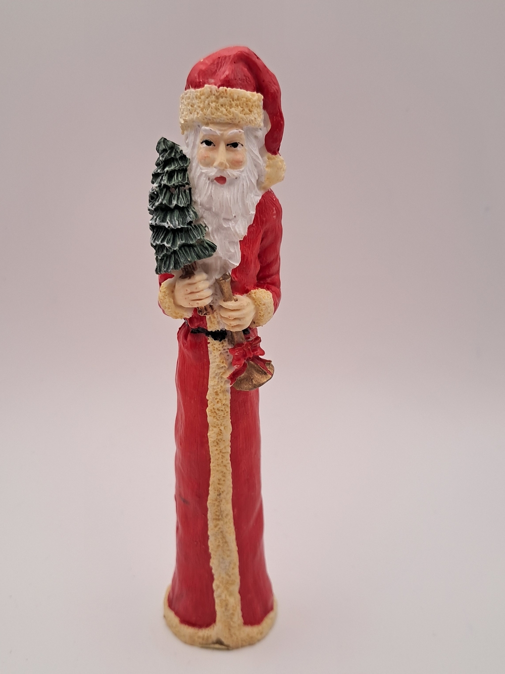 Festive Red Santa Figurine with Green Tree Accent